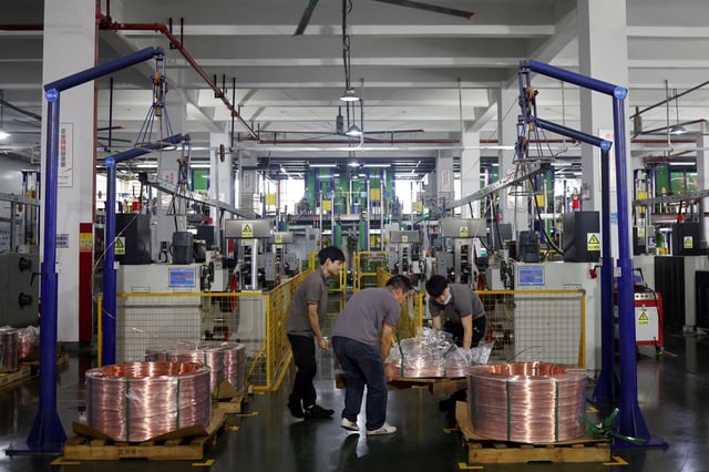 Employees move copper rod on a pallet on the production line for copper flat wire at the Wellascent factory in Ganzhou, Jiangxi province, China August 14, 2025. REUTERS/Florence Lo/File Photo