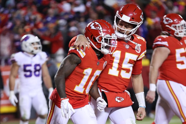 KANSAS CITY, MISSOURI - JANUARY 23: Tyreek Hill #10 of the Kansas City Chiefs celebrates with teammate Patrick Mahomes #15 after scoring a 64 yard touchdown against the Buffalo Bills during the fourth quarter in the AFC Divisional Playoff game at Arrowhead Stadium on January 23, 2022 in Kansas City, Missouri. Hill had an interesting post after the latest Chiefs trade.