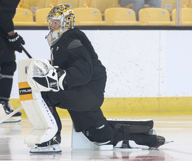 Boston Bruins goalie Jeremy Swayman stretches during the first day of training camp, Thursday, at Warrior Ice Arena in Boston. (Mark Stockwell/Boston Herald)