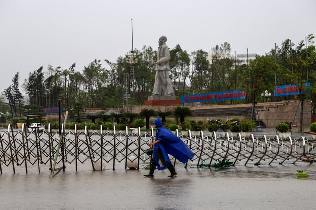 A man walks on a flooded street after Typhoon Bualoi makes landfall in Nghe An province, Vietnam, September 29, 2025. REUTERS/Thinh Nguyen