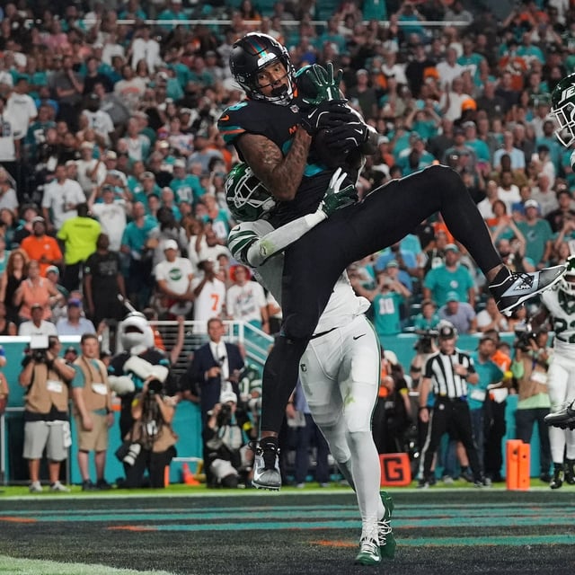 Miami Dolphins tight end Darren Waller (83) catches a touchdown pass as New York Jets' Sauce Gardner, rear, and Brandon Stephens (21) defend in the first half of an NFL football game, Monday, Sept. 29, 2025, in Miami Gardens, Fla. (AP Photo/Marta Lavandier)