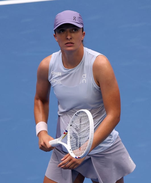Tennis - China Open - The Beijing Olympic Green Tennis Center, Beijing, China - September 27, 2025 Poland's Iga Swiatek reacts after winning her round of 64 match against China's Yue Yuan REUTERS/Tingshu Wang