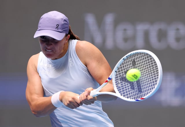 Tennis - China Open - The Beijing Olympic Green Tennis Center, Beijing, China - September 27, 2025 Poland's Iga Swiatek in action during her round of 64 match against China's Yue Yuan REUTERS/Tingshu Wang