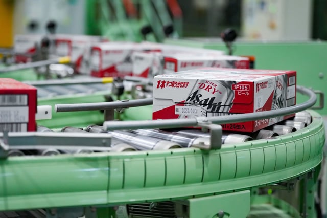 Boxes containing cans of Asahi Super Dry beer move on the production line inside the Asahi Breweries Ibaraki plant, operated by Asahi Breweries Holdings, in Moriya, Japan.