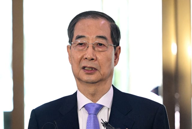 South Korean Prime Minister Han Duck-soo speaks to the media as he arrives at the Government Complex in Seoul on March 24, 2025.   JUNG YEON-JE/Pool via REUTERS/File Photo