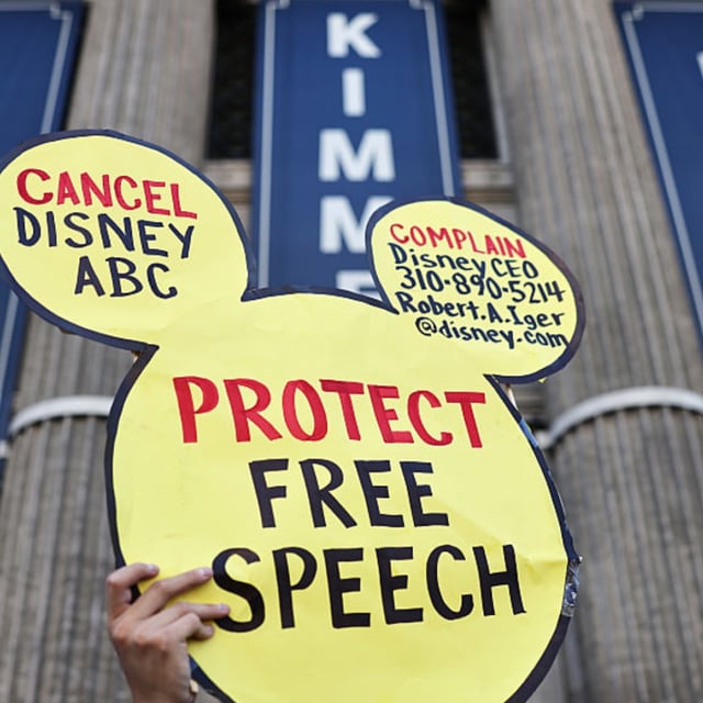 A demonstrator waves a "Protect Free Speech" sign following a protest against the suspension of the "Jimmy Kimmel Live!" show, held near the theater where the show is produced in Hollywood, on September 22, 2025 in Los Angeles, California.