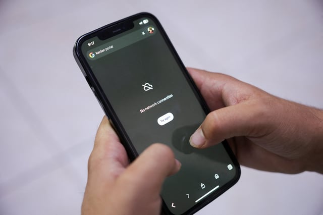 A man tries to use Google on his smartphone amid total telecom shutdown across the country, in Kabul, Afghanistan, September 30, 2025. REUTERS/Sayed Hassib