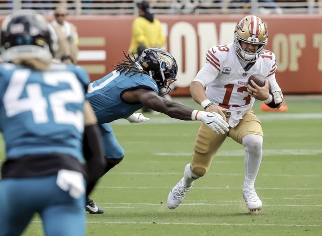 49ers quarterback Brock Purdy scrambles for a first down in the first half, one of his two carries in the game, in a 26-21 loss Sunday to the Jacksonville Jaguars at Levi’s Stadium.