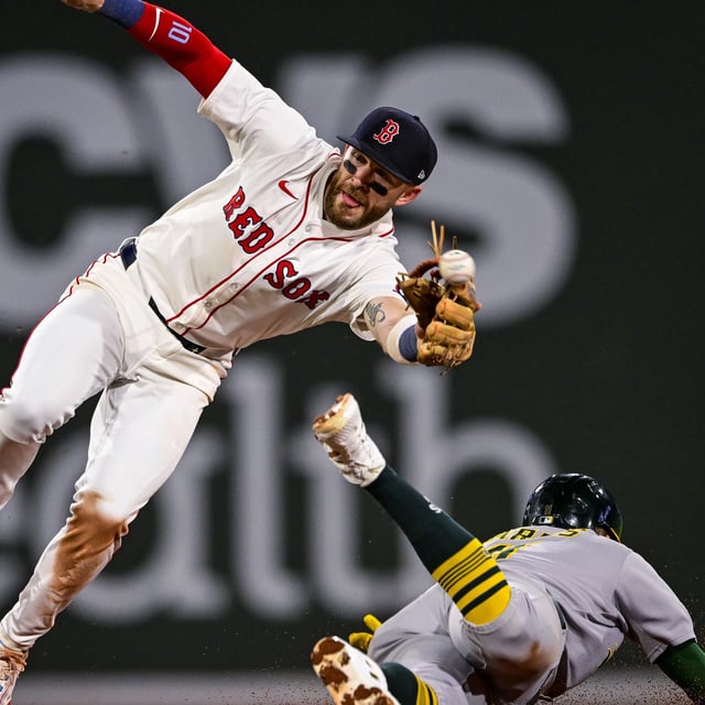 Brett Harris #11 of the Athletics safely steals second base against Trevor Story #10 of the Boston Red Sox in the fourth inning at Fenway Park on September 17, 2025 in Boston, Massachusetts. 