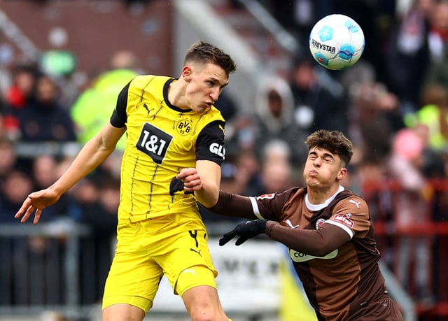 Soccer Football - Bundesliga - FC St. Pauli v Borussia Dortmund - Millerntor-Stadion, Hamburg, Germany - March 1, 2025 Borussia Dortmund's Nico Schlotterbeck in action with FC St. Pauli's Noah Weisshaupt REUTERS/Lisi Niesner/File Photo