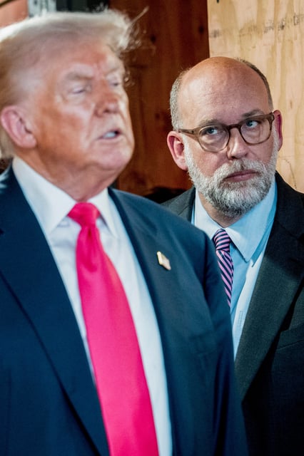 Russell Vought, director of the Office of Management and Budget, listens to President Donald Trump during a tour of renovations at the Federal Reserve in Washington, July 24, 2025.