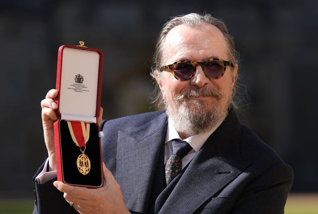WINDSOR, ENGLAND - SEPTEMBER 30: Sir Gary Oldman poses after being made a Knight Bachelor at an investiture ceremony at Windsor Castle on September 30, 2025 in Windsor, England.  (Photo by Andrew Matthews-WPA Pool/Getty Images)