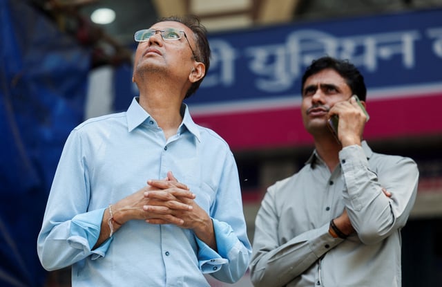 Men watch market results on a screen outside the Bombay Stock Exchange (BSE) in Mumbai, India, April 7, 2025. REUTERS/Francis Mascarenhas
