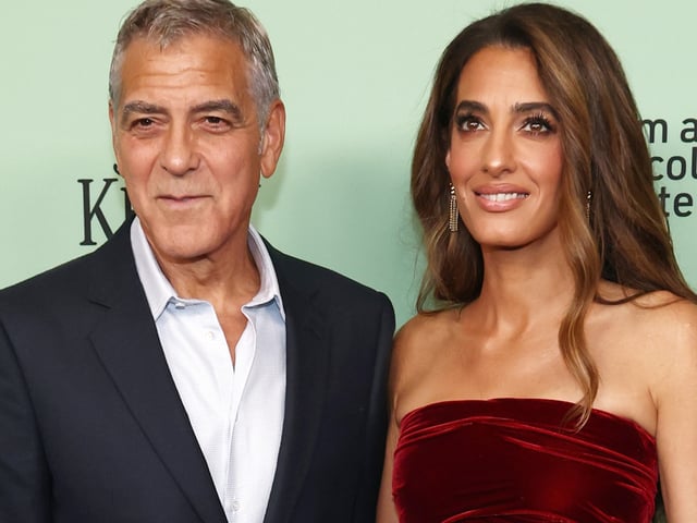 Amal Clooney wore a red velvet mini dress from Oscar de la Renta Fall 2025 at the Jay Kelly premiere