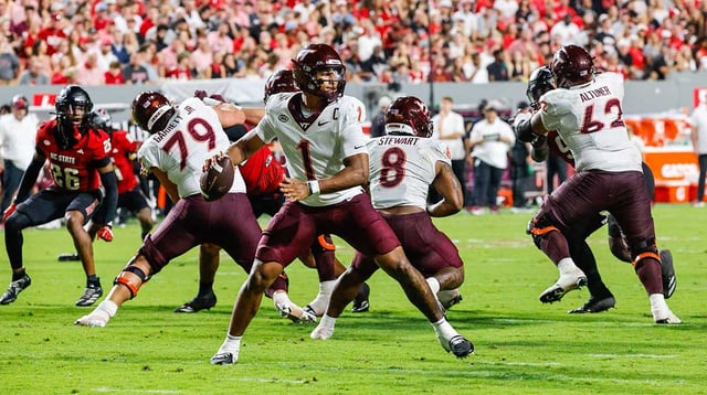 Sep 27, 2025; Raleigh, North Carolina, USA; Virginia Tech Hokies quarterback Kyron Drones (1) attempts to throw the ball during the first half of the game against North Carolina State Wolfpack at Carter-Finley Stadium. Mandatory Credit: Jaylynn Nash-Imagn Images