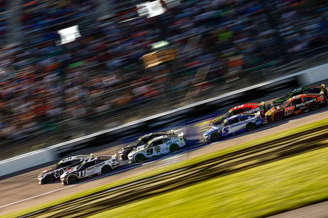 KANSAS CITY, KANSAS - SEPTEMBER 28: Denny Hamlin, driver of the #11 Sport Clips Haircuts Toyota, Christopher Bell, driver of the #20 Rheem Toyota, Chase Elliott, driver of the #9 Kelley Blue Book Chevrolet, and Kyle Larson, driver of the #5 HendrickCars.com Chevrolet, race during the NASCAR Cup Series Hollywood Casino 400 Presented by ESPN BET at Kansas Speedway on September 28, 2025 in Kansas City, Kansas. (Photo by Sean Gardner/Getty Images)
