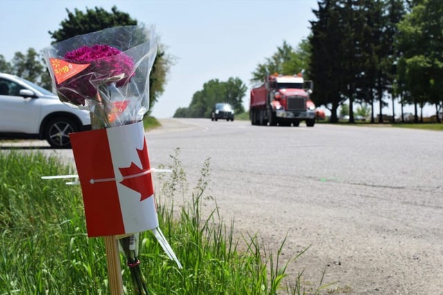 Flowers were laid on Tueday, May 30, 2023, at the intersection of Oxford County Road 33 and Highway 59, where a collision a day earlier between a school bus and unmarked Ontario Provincial Police vehicle killed both drivers. (Calvi Leon/The London Free Press)