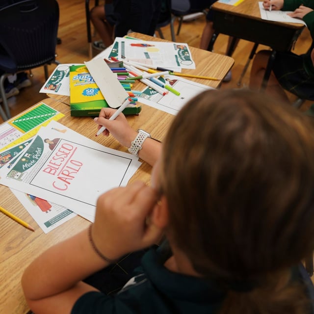 FILE - Fifth grade students at St. John Berchmans' school draw pictures of Blessed Carlo Acutis, who will be canonized a saint by Pope Leo XIV, during a class activity on Wednesday, Sept. 3, 2025, in Chicago. (AP Photo/Jessie Wardarski)