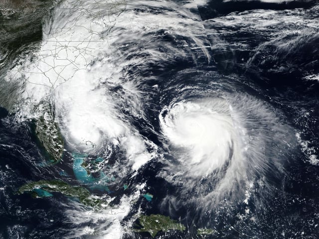 This Monday, Sept. 29, 2025, satellite image released by NASA shows Tropical Storm Imelda, left, and Hurricane Humberto in the Atlantic Ocean. (NASA Worldview, Earth Observing System Data and Information System (EOSDIS) via AP)