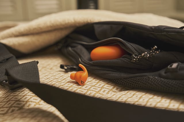 Powerbeats Fit showing in orange.