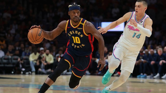 Mar 25, 2025; Miami, Florida, USA; Golden State Warriors forward Jimmy Butler III (10) drives to the basket past Miami Heat guard Tyler Herro (14) during the first quarter at Kaseya Center. Mandatory Credit: Sam Navarro-Imagn Images