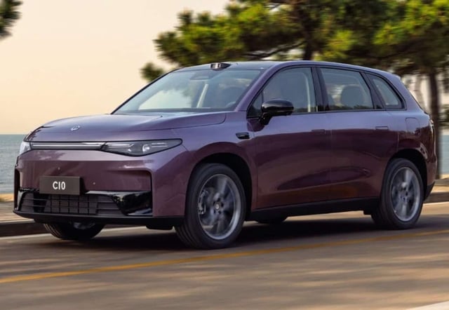 A sleek, modern electric SUV driving along the picturesque South African coastline, highlighting innovative green transportation.