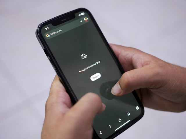 A man tries to use Google on his smartphone amid total telecom shutdown across the country, in Kabul, Afghanistan, September 30, 2025. REUTERS/Sayed Hassib