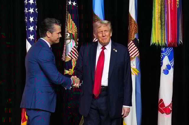 President Donald Trump greets Secretary of War Pete Hegseth as he arrives to speak to senior military leaders at Marine Corps Base Quantico in Northern Virginia on Sept. 30, 2025.