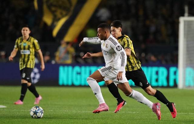 Soccer Football - UEFA Champions League - Kairat v Real Madrid - Central Stadium, Almaty, Kazakhstan - September 30, 2025 Real Madrid's Kylian Mbappe in action with Kairat's Damir Kasabulat REUTERS/Pavel Mikheyev
