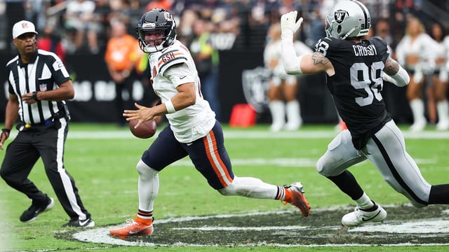 Sep 28, 2025; Paradise, Nevada, USA; Chicago Bears quarterback Caleb Williams (18) looks for an open receiver while being pressured by Las Vegas Raiders defensive end Maxx Crosby (98) in the second quarter at Allegiant Stadium. Mandatory Credit: Kiyoshi Mio-Imagn Images