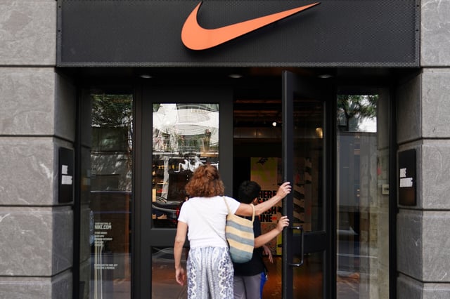 People walk into a Nike store in New York City, New York, U.S., September 4, 2018. REUTERS/Carlo Allegri