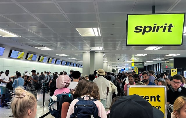 Travelers stand in line at the check-in counter at Spirit Airlines at Newark Liberty International Airport, in Newark, New Jersey, U.S., June 30, 2025. REUTERS/Sami Marshak/File Photo