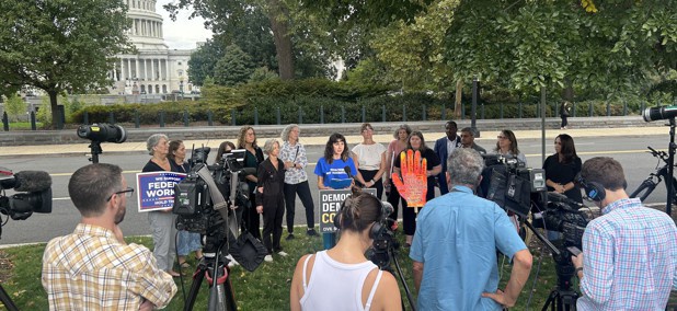 Helen Luryi, formerly of the Labor Department, wears a shirt that says "tenacious not traumatized," which is a reference to comments made by OMB Director Russell Vought, during a press conference near the U.S. Capitol.
