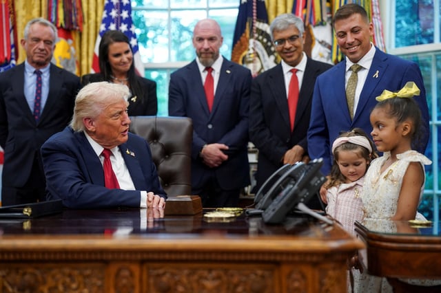 U.S. President Donald Trump interacts with children in the Oval Office, on the day he signs an executive order on AI and pediatric cancer research, at the White House, Washington, D.C., U.S., September 30, 2025. REUTERS/Nathan Howard