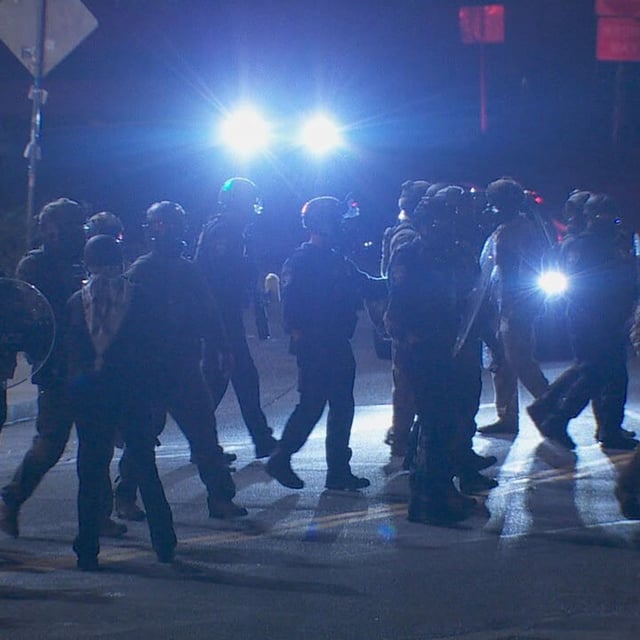 Protesters walk across the street from the ICE facility after agents used pepper spray - KATU photo