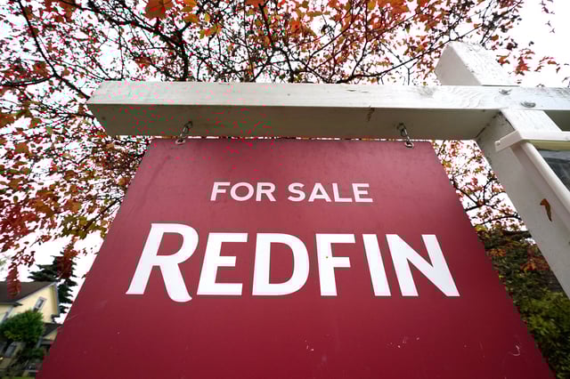 FILE - A Redfin "for sale" sign stands in front of a house on Oct. 28, 2020, in Seattle. (AP Photo/Elaine Thompson, File)
