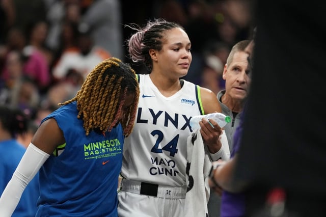 An injured Minnesota Lynx forward Napheesa Collier is helped off the court during the second half of Game 3 of a WNBA basketball playoff semifinals series game against the Phoenix Mercury Friday, Sept. 26, 2025, in Phoenix. (AP Photo/Ross D. Franklin)