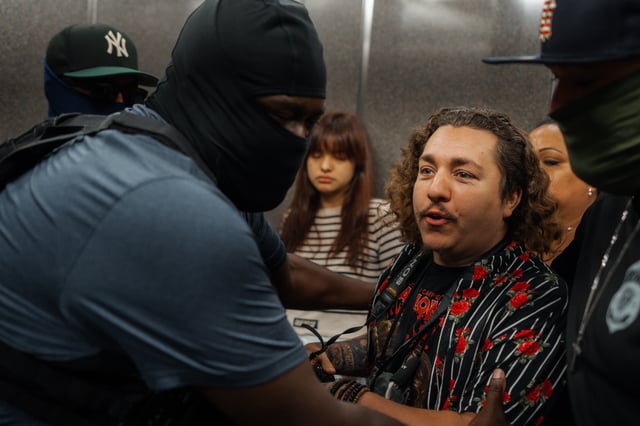 Federal agents push photojournalist Dean Moses while making a detention in immigration court on Tuesday, Sept. 30, 2025, in New York. (AP Photo/Olga Fedorova)