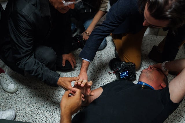 Bystanders assist journalist Vural Elibol as he lies on the floor after being shoved while covering detentions in immigration court on Tuesday, Sept., 30, 2025, in New York. (AP Photo/Olga Fedorova)
