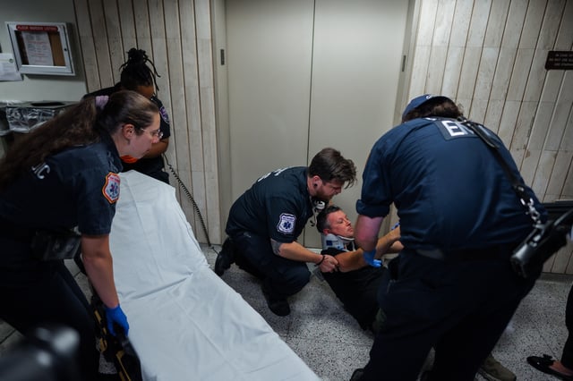 Medics transfer journalist L. Vural Elibol to a gurney after he was shoved by federal agents in immigration court on Tuesday, Sept. 30, 2025, in New York. (AP Photo/Olga Fedorova)