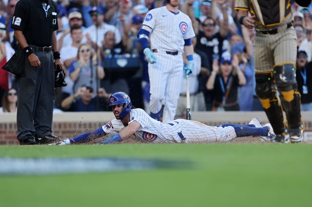 CHICAGO, ILLINOIS – SEPTEMBER 30: Dansby Swanson #7 of the Chicago Cubs slides into home plate to score a run during the eighth inning of game one of the National League Wild Card Series between the San Diego Padres and the Chicago Cubs at Wrigley Field on September 30, 2025 in Chicago, Illinois. (Photo by Michael Reaves/Getty Images)