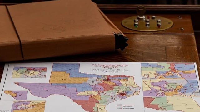 A map of the proposed changes to Texas congressional districts sits on a Texas House member’s desk on Aug. 20, 2025