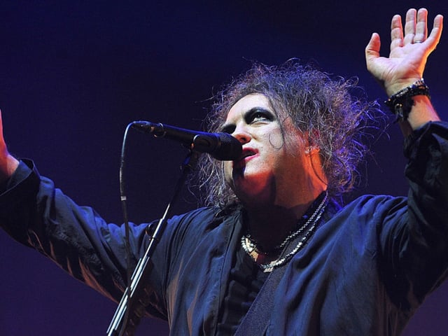 Robert Smith of The Cure performs live on stage at Wembley Arena on December 1, 2016 in London, England.