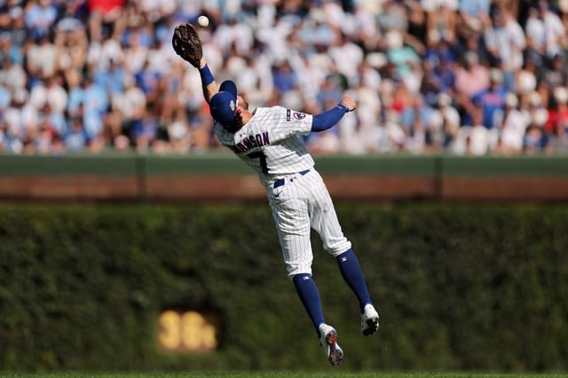 Dansby Swanson #7 of the Chicago Cubs leaps to make a catch during the fourth inning of game one of the National League Wild Card Series between the San Diego Padres and the Chicago Cubs at Wrigley Field on Sept. 30, 2025 in Chicago, Illinois. (Photo by Michael Reaves/Getty Images)