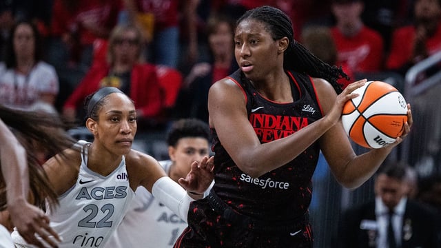 Sep 28, 2025; Indianapolis, Indiana, USA; Indiana Fever forward Aliyah Boston (7) holds the ball while Las Vegas Aces center A'ja Wilson (22) defends in the second half during game four of the second round for the 2025 WNBA Playoffs at Gainbridge Fieldhouse. Mandatory Credit: Trevor Ruszkowski-Imagn Images
