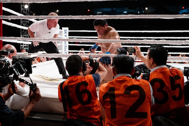 Dwayne Johnson, center, portrays early MMA fighter Mark Kerr in Benny Safdie’s “The Smashing Machine.”