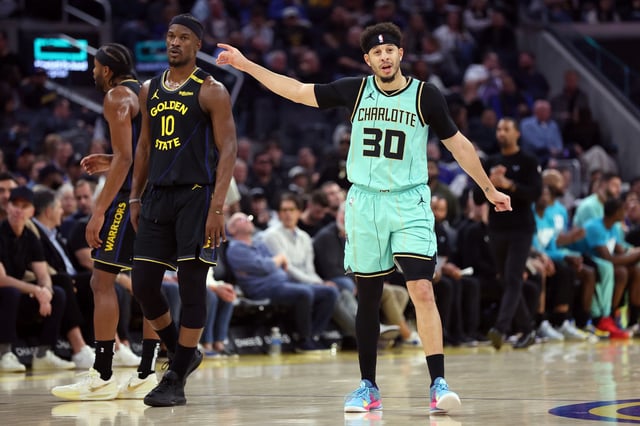Charlotte Hornets guard Seth Curry celebrates near Warriors forward Jimmy Butler III at Chase Center on Feb. 25.