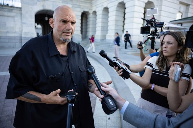 Sen. John Fetterman (D-Pa.) speaks with reporters outside the U.S. Capitol Sept. 8, 2025. (Francis Chung/POLITICO via AP Images)