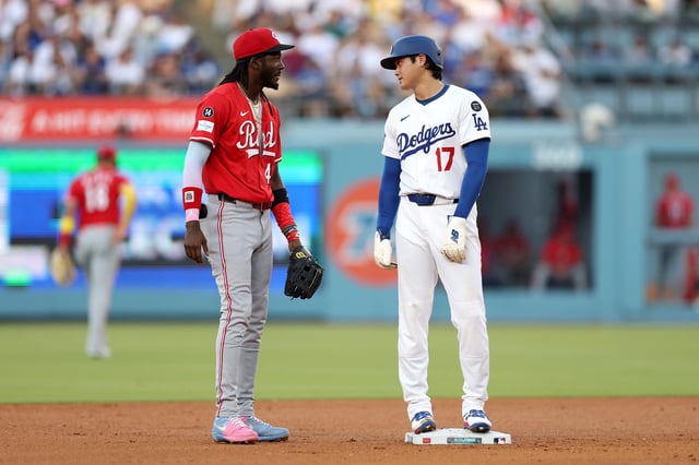 Shohei Ohtani #17 of the Los Angeles Dodgers interacts with Elly De La Cruz #44 of the Cincinnati Reds during the fourth inning at Dodger Stadium on August 27, 2025 in Los Angeles, California.
