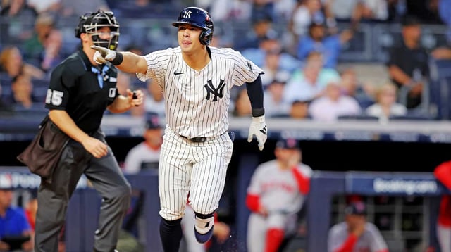 Sep 30, 2025; Bronx, New York, USA; New York Yankees shortstop Anthony Volpe (11) hits a solo home run during the first inning against the Boston Red Sox during game one of the Wildcard round for the 2025 MLB playoffs at Yankee Stadium. Mandatory Credit: Brad Penner-Imagn Images